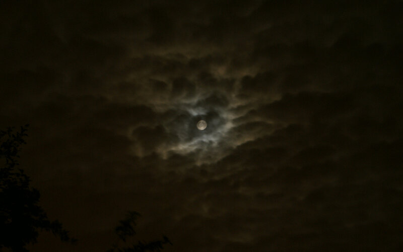 Moon through cloudy night sky
