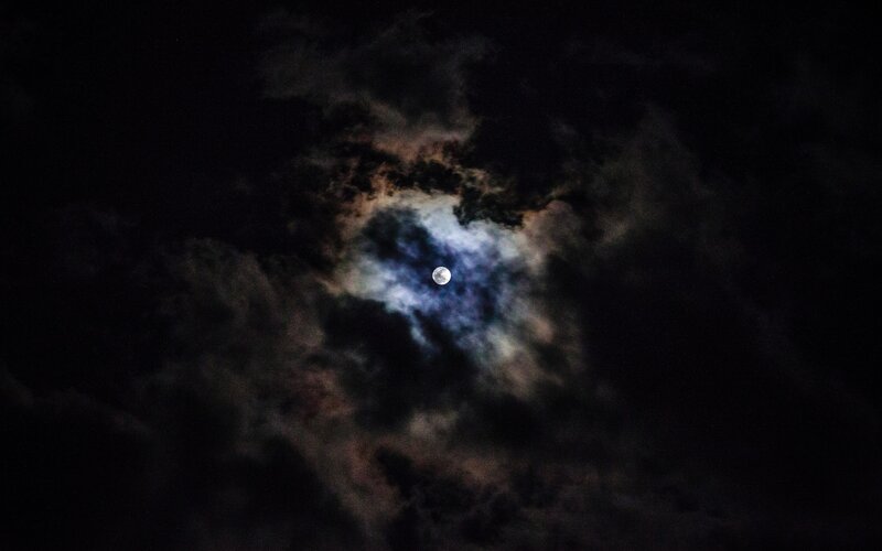 Moon through cloudy night sky