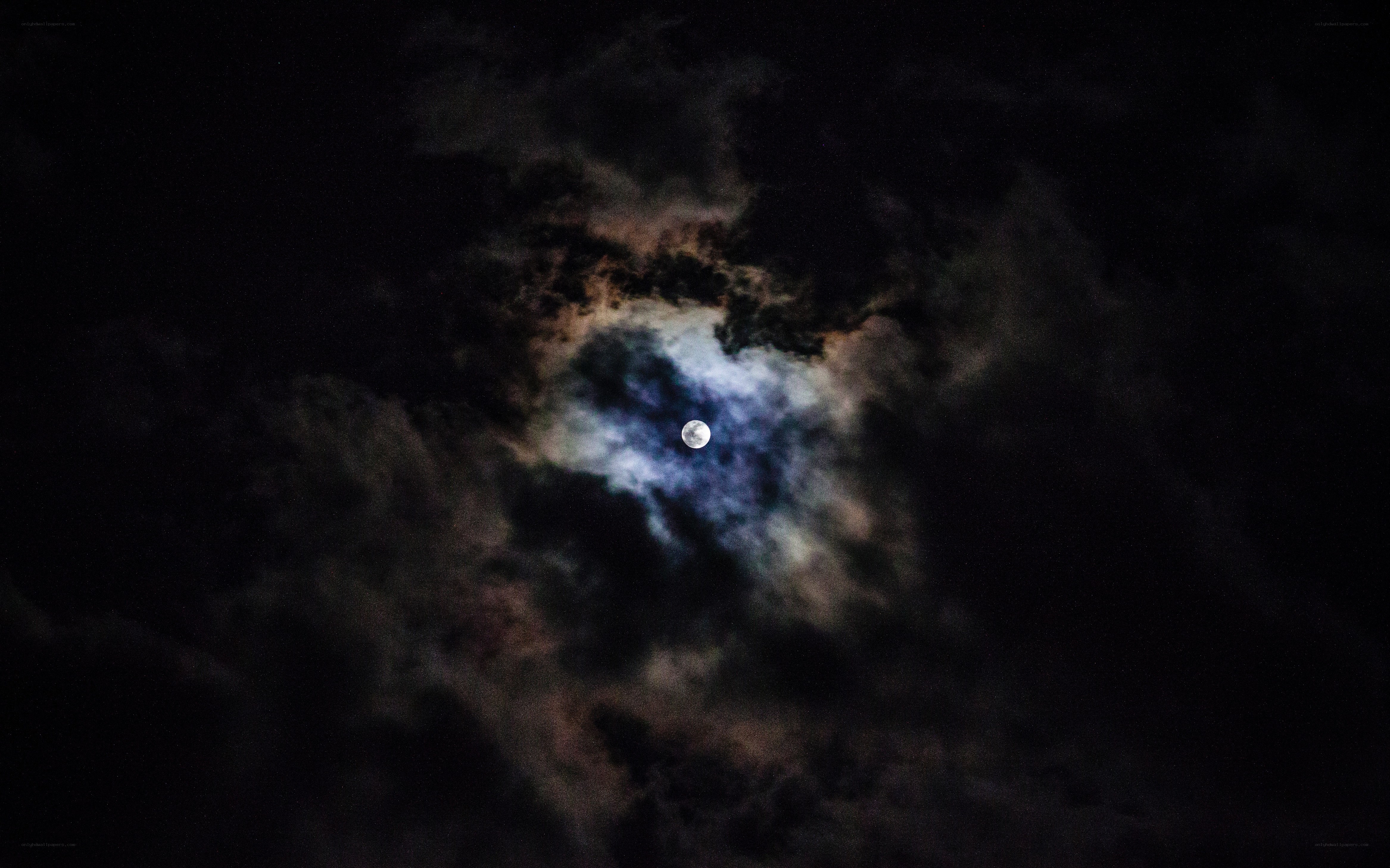 Moon through cloudy night sky