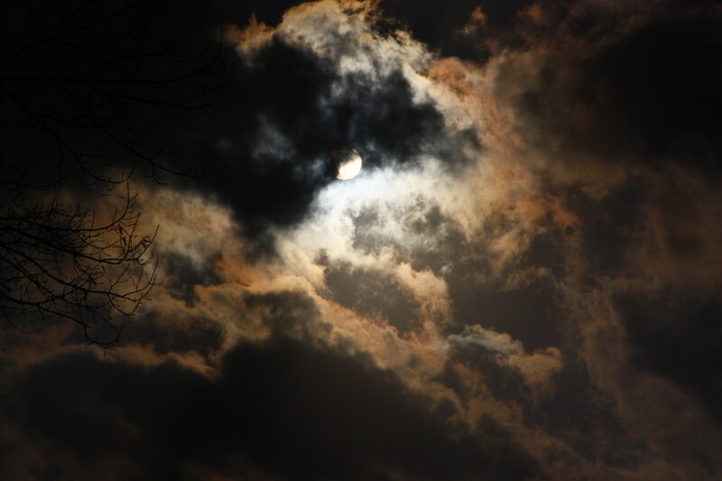 Moon through cloudy sky