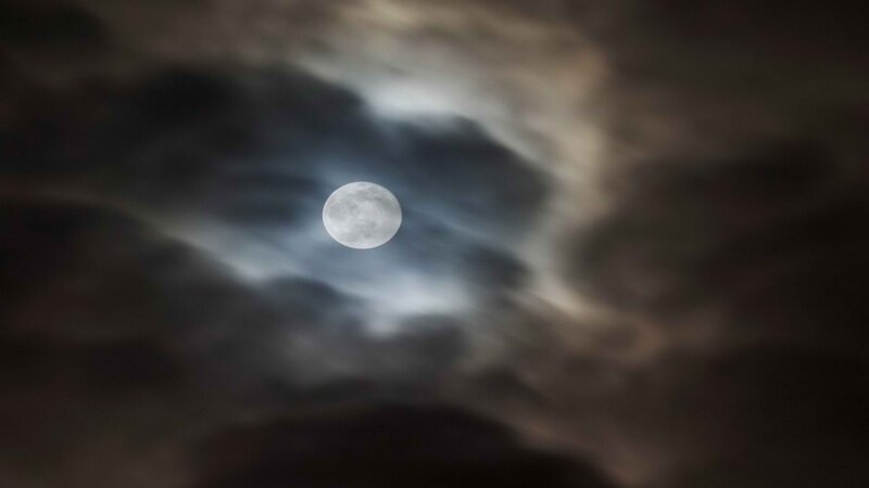 Moon through cloudy sky