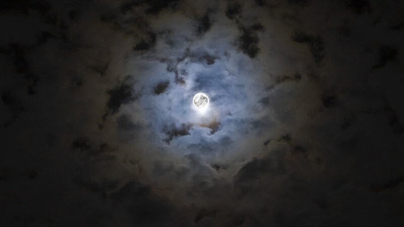 Moon through cloudy sky