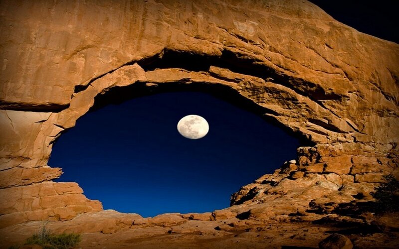 Moon through natural arch