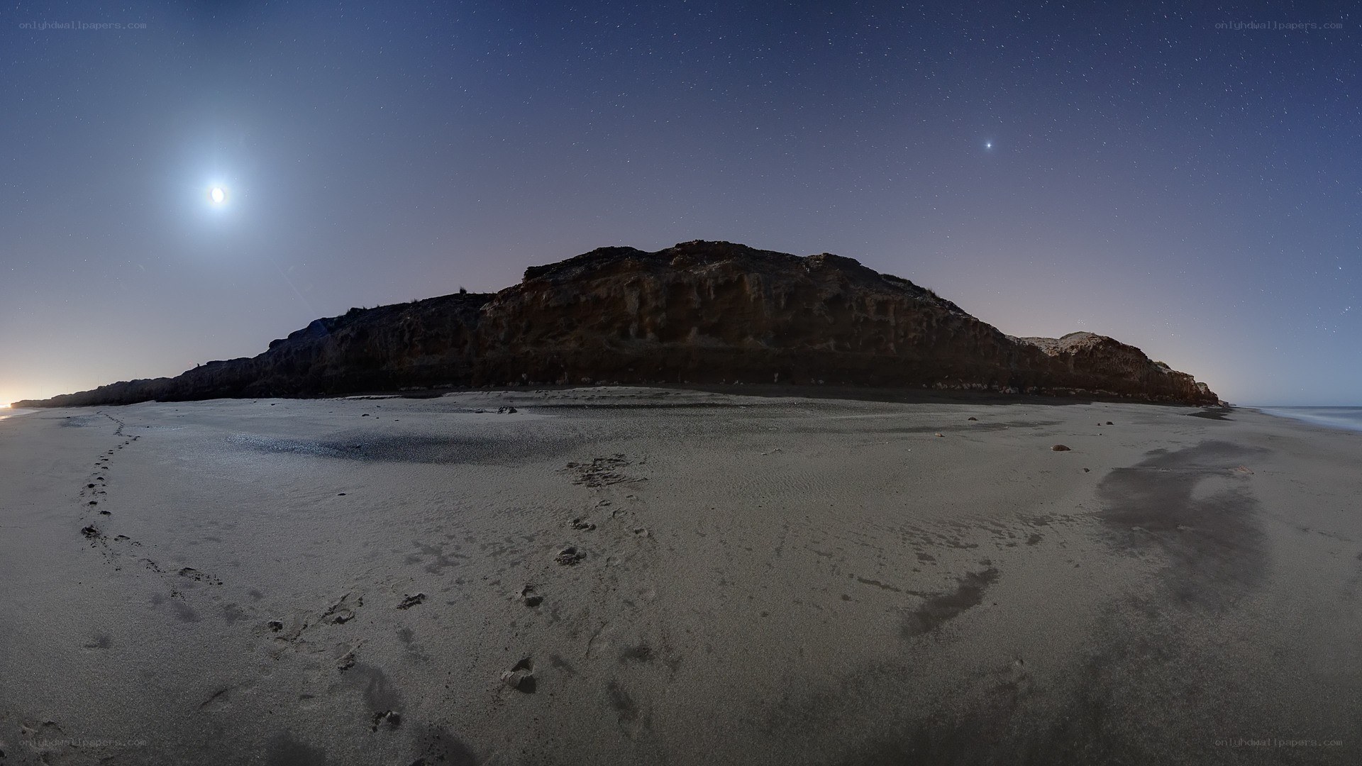 Moonlit beach at night