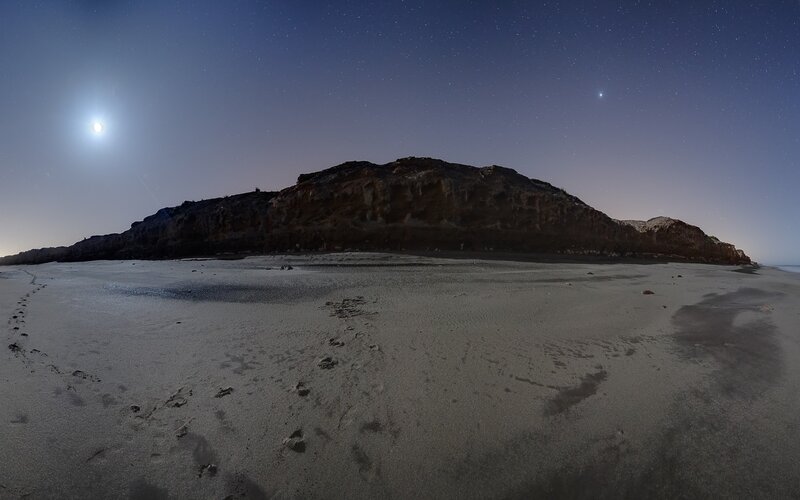 Moonlit beach at night