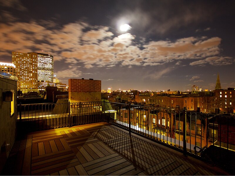 Moonlit city rooftop view