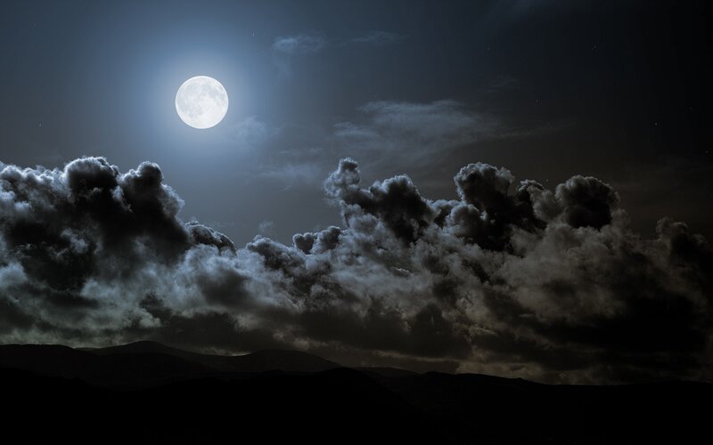Moonlit clouds over mountains