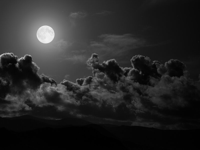 Moonlit clouds over mountains