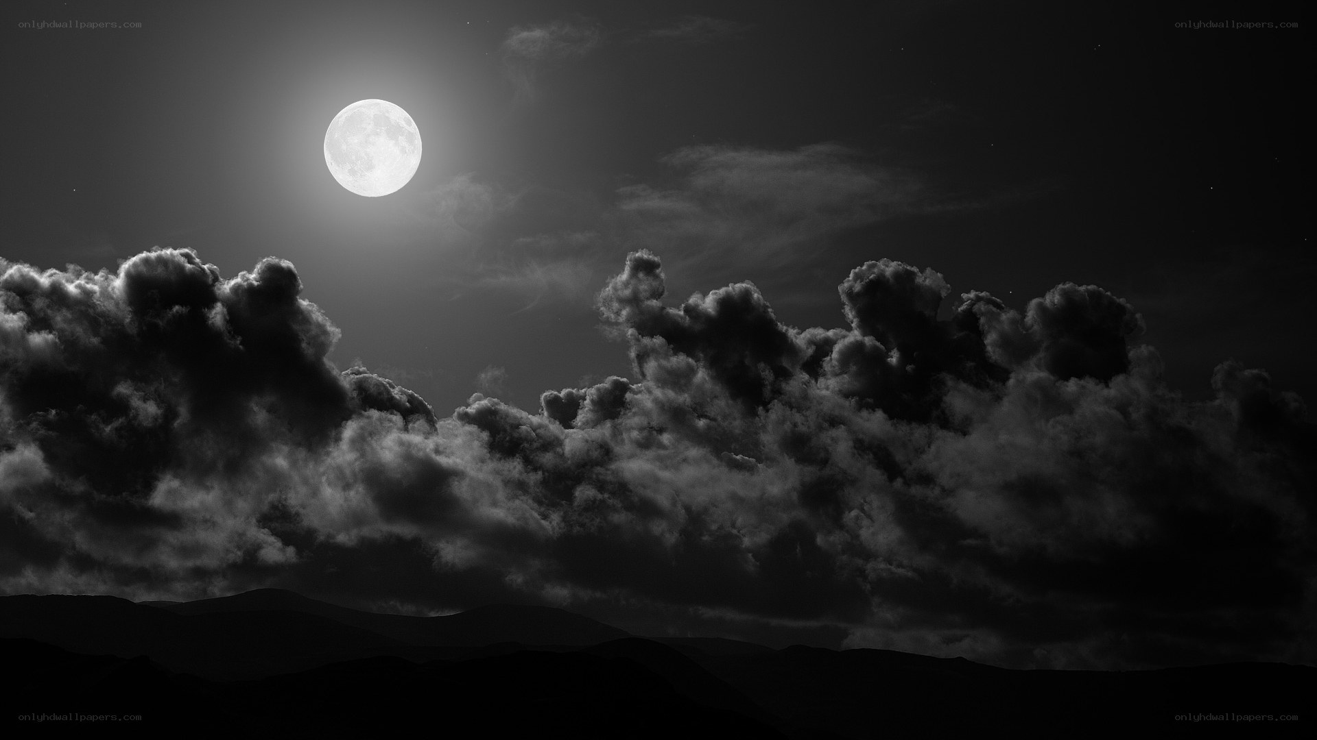 Moonlit clouds over mountains