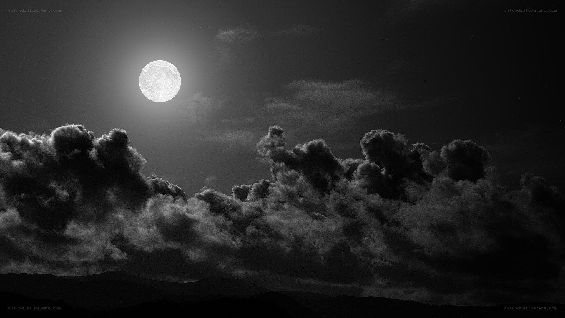 Moonlit clouds over mountains