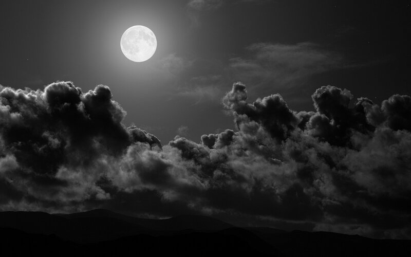 Moonlit clouds over mountains