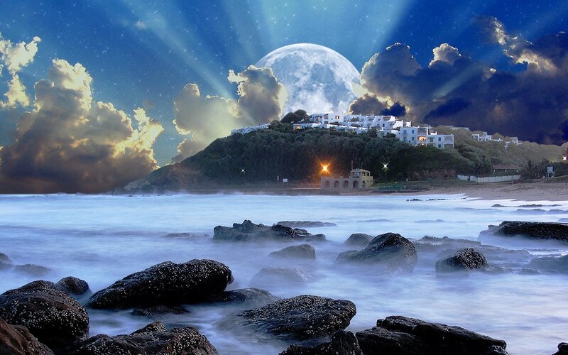 Moonlit coastal village at night