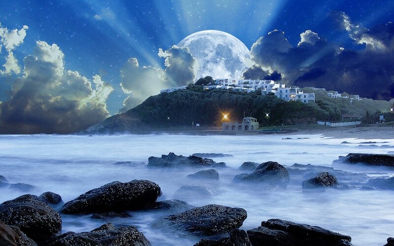 Moonlit coastal village at night