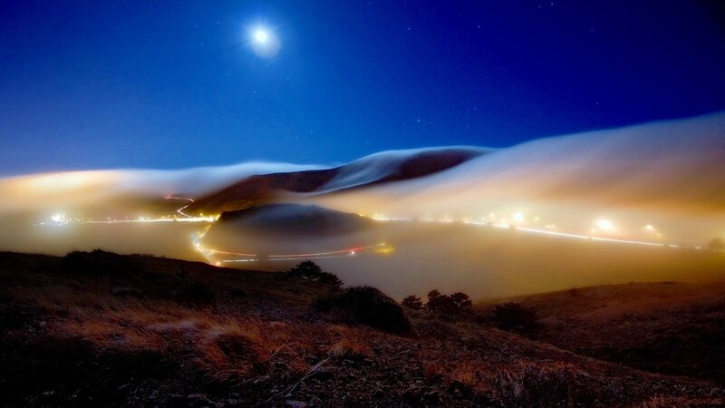 Moonlit fog over winding roads