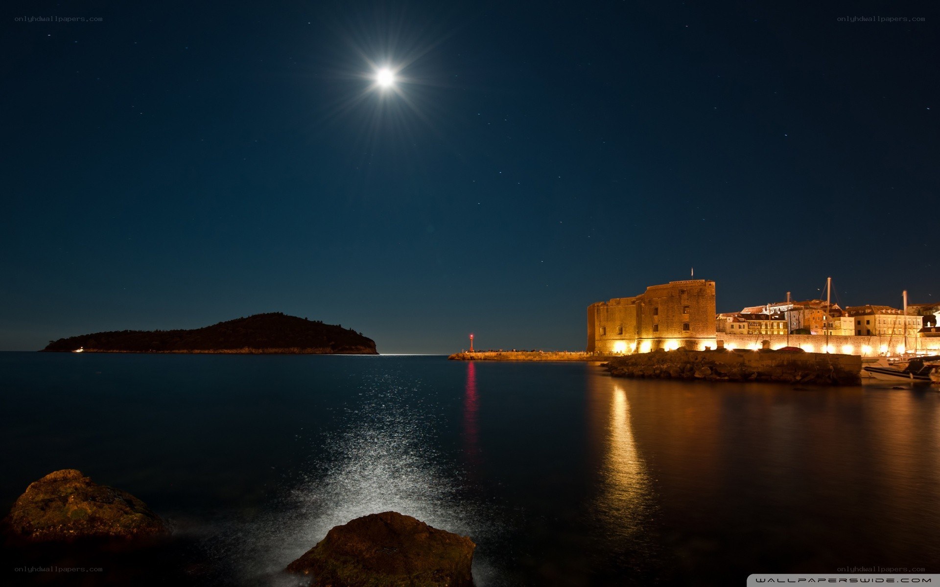 Moonlit harbor at night