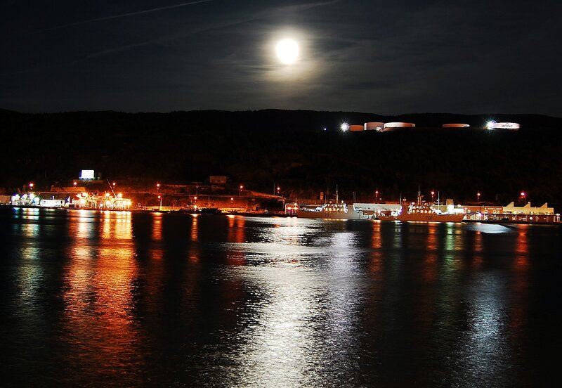 Moonlit harbor at night