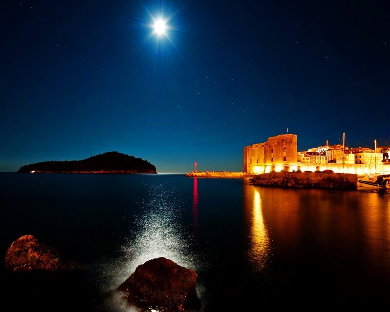 Moonlit harbor at night