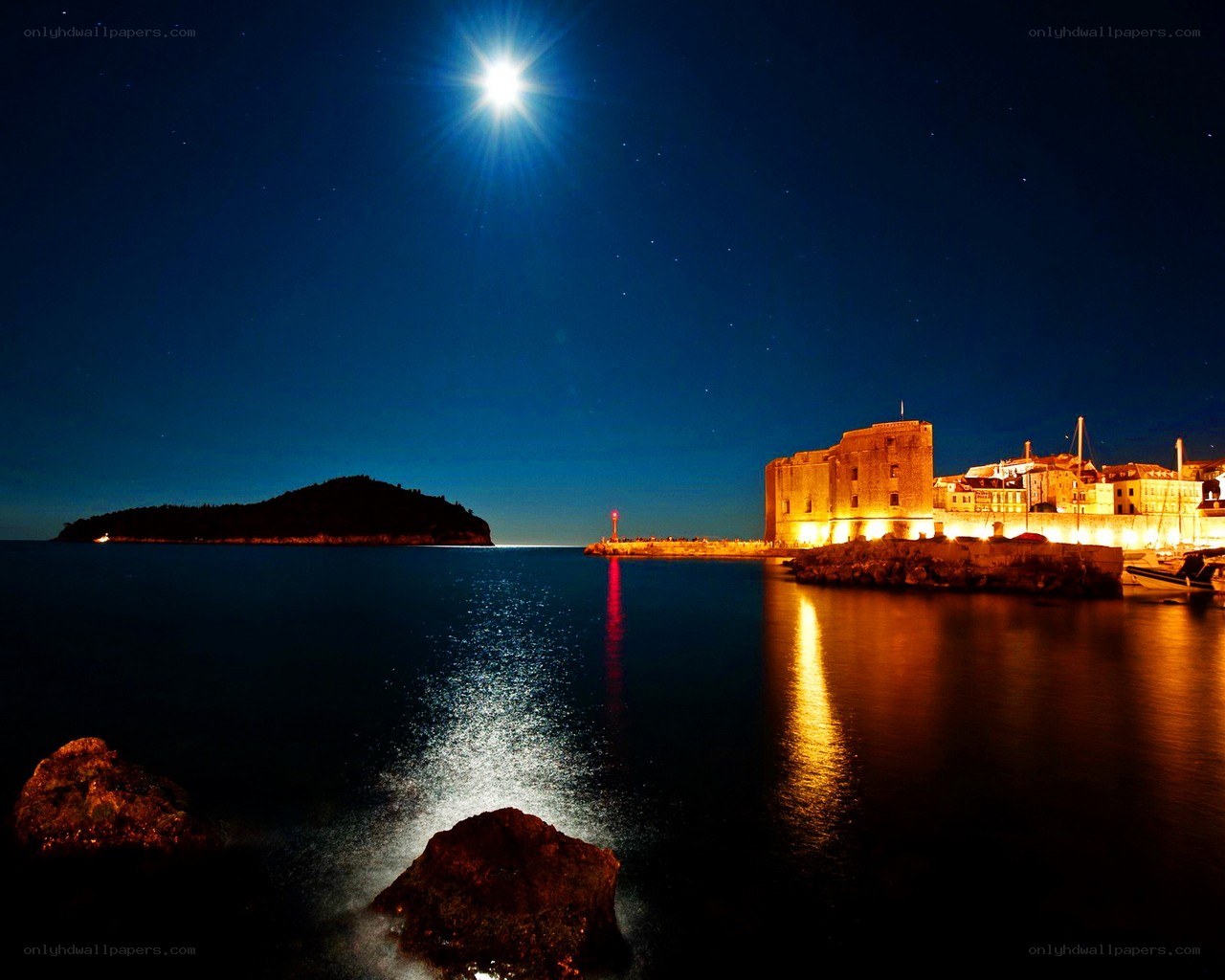 Moonlit harbor at night