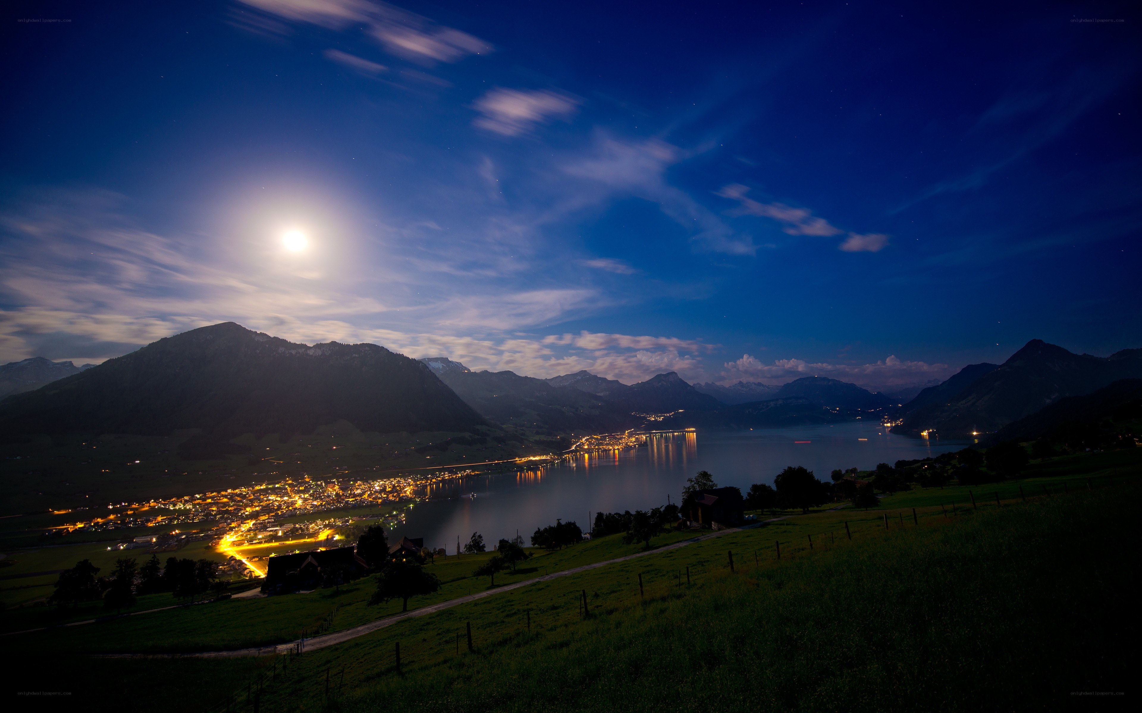 Moonlit lake and mountains at night