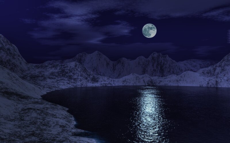 Moonlit lake in snowy mountains