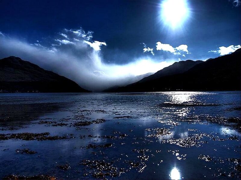 Moonlit lake with mountain shadows