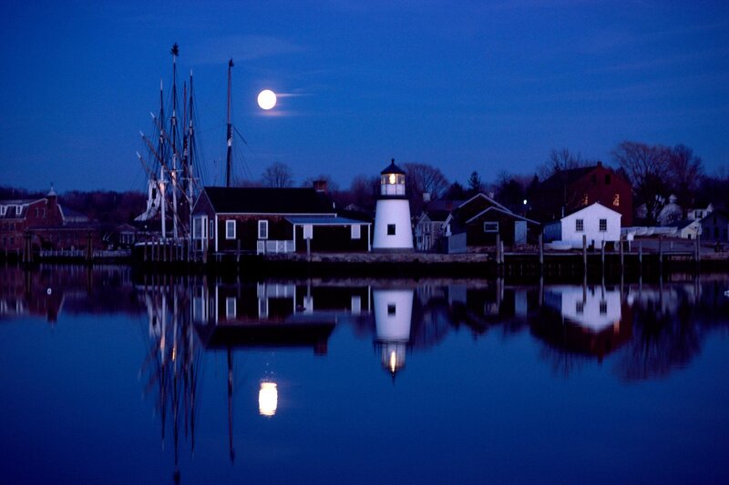 Moonlit lighthouse at dusk