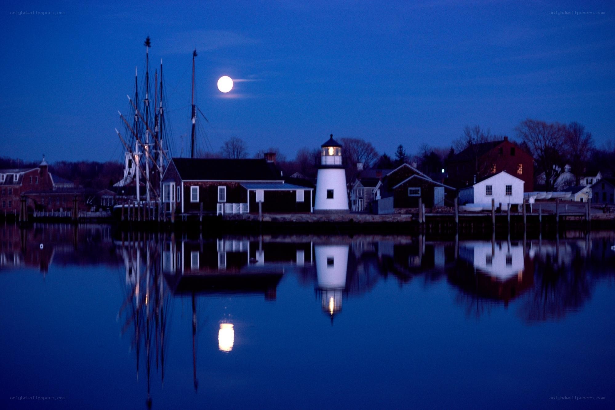 Moonlit lighthouse at dusk