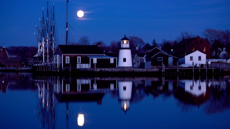 Moonlit lighthouse at dusk