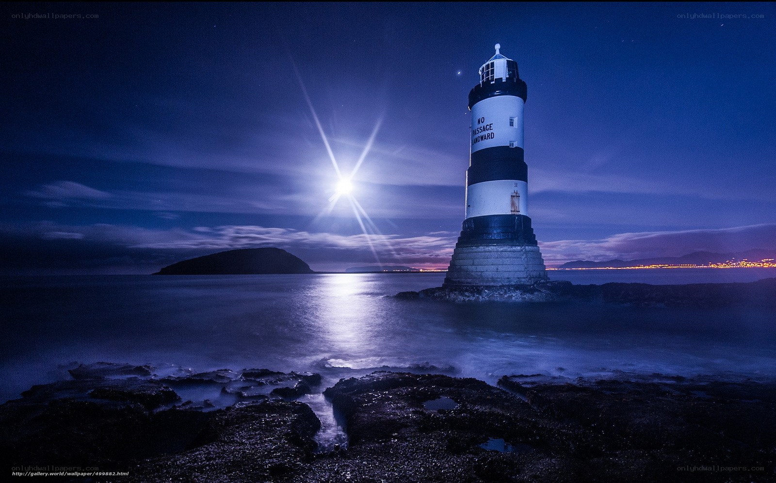 Moonlit lighthouse at night