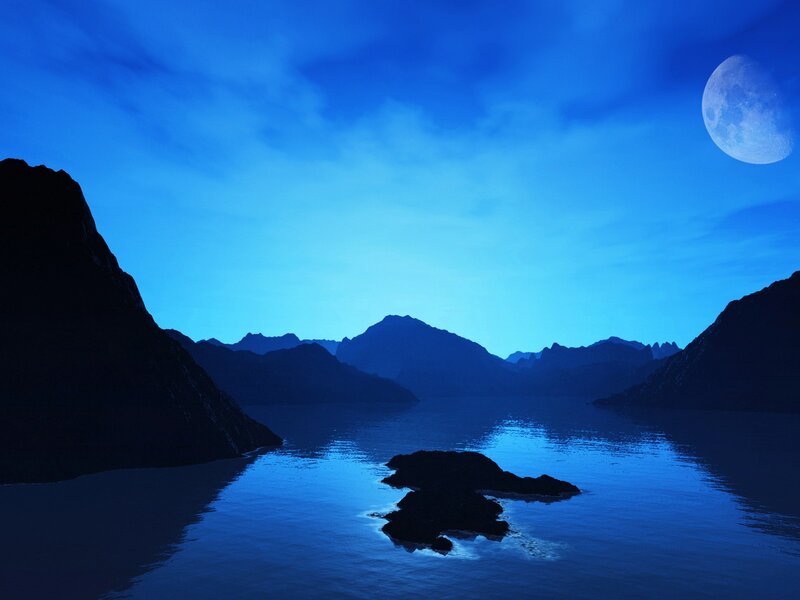 Moonlit mountain lake at night