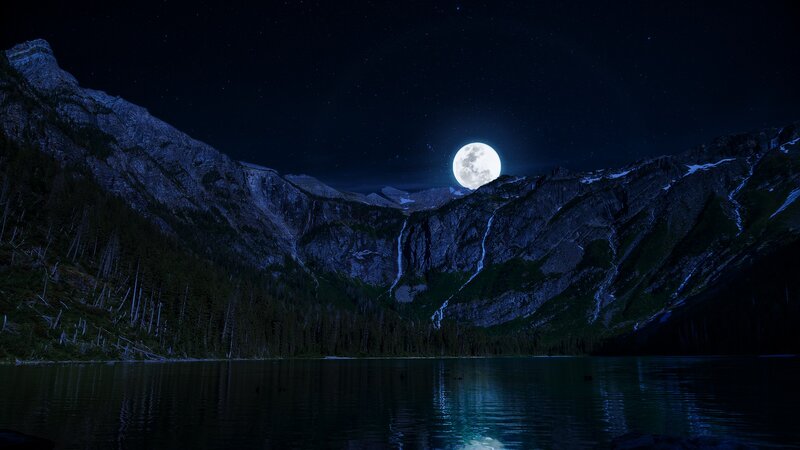 Moonlit mountain lake at night