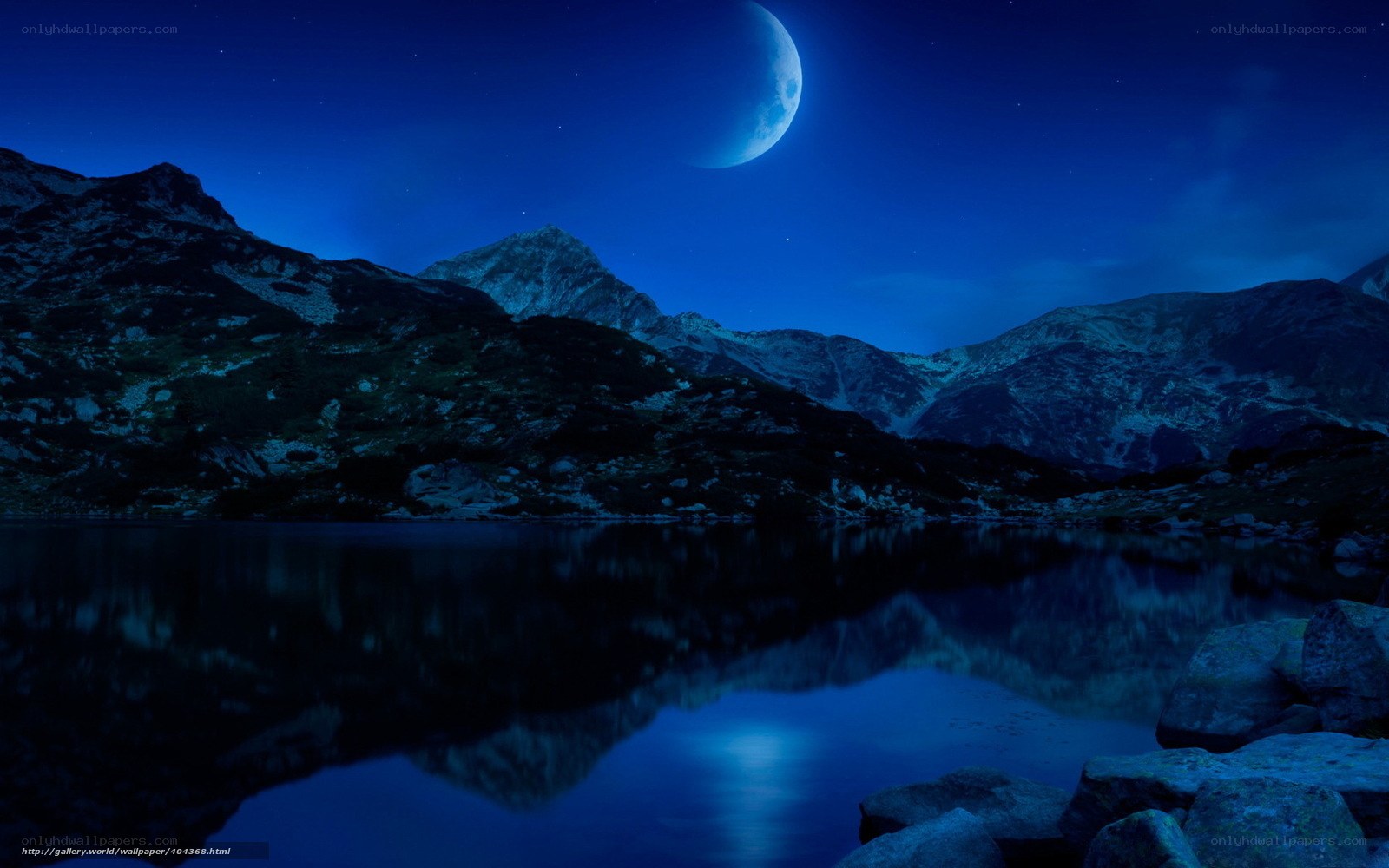 Moonlit mountain lake at night
