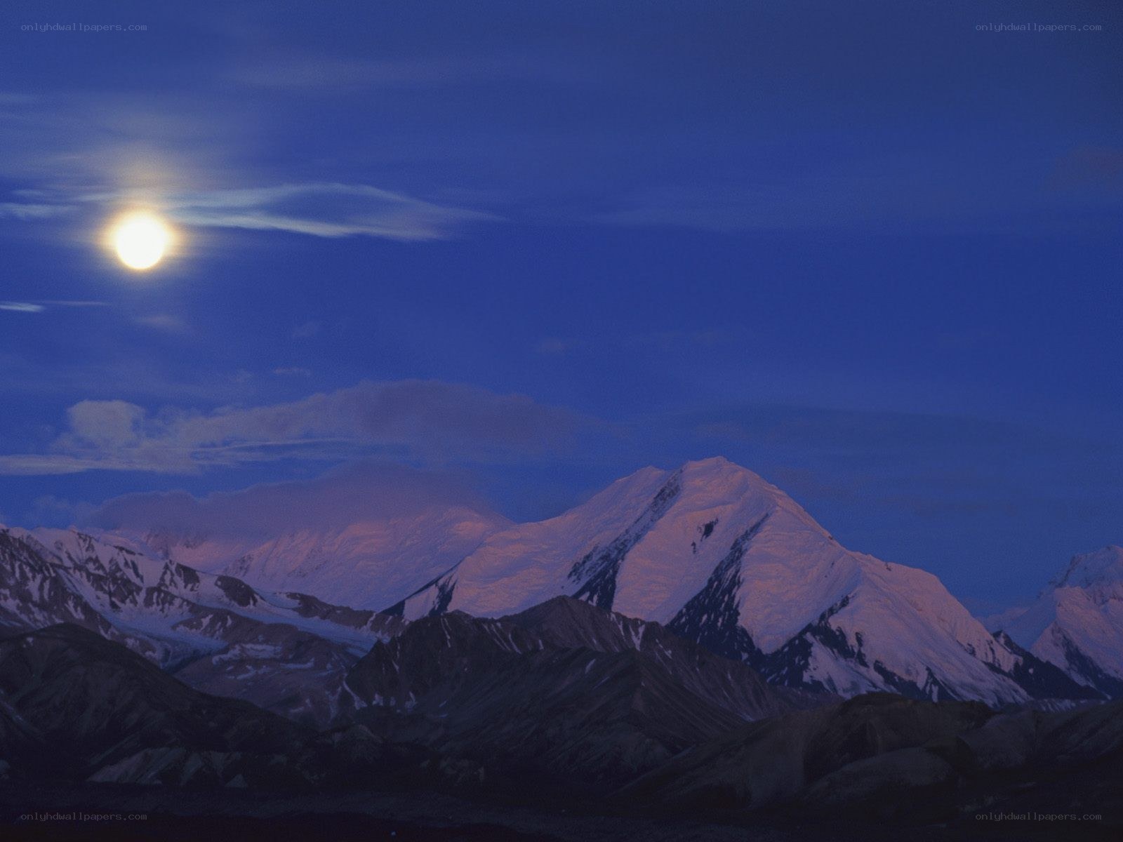 Moonlit mountain peaks at dusk