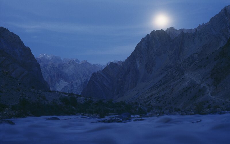 Moonlit mountain valley at dusk