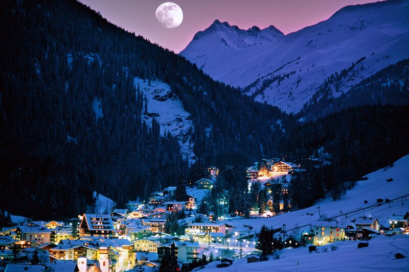 Moonlit mountain village at night
