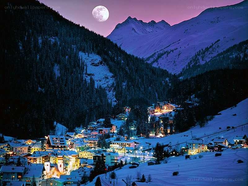 Moonlit mountain village at night
