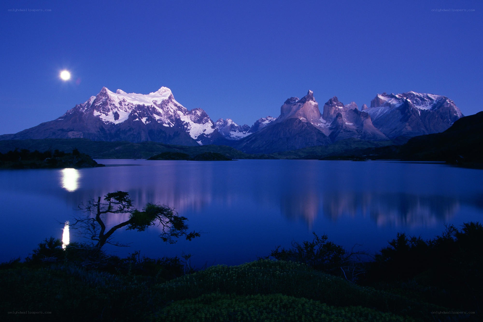 Moonlit mountains reflected in a lake