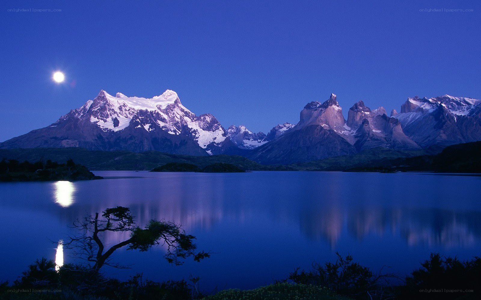 Moonlit mountains reflected in a lake