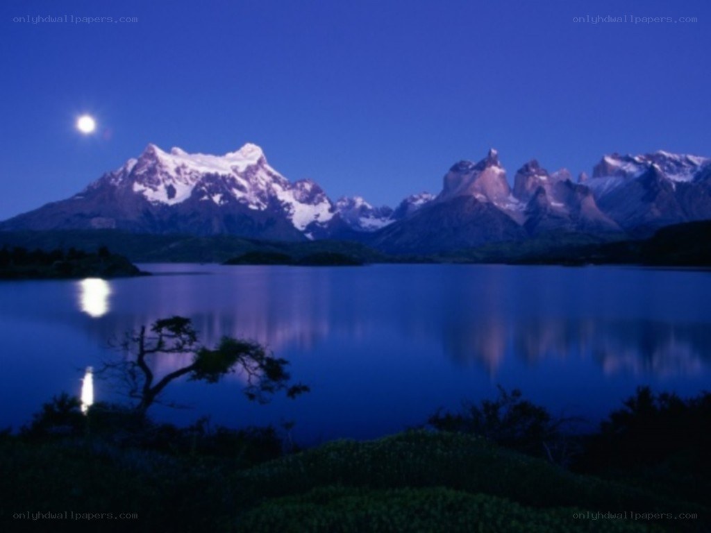 Moonlit mountains reflected in a lake