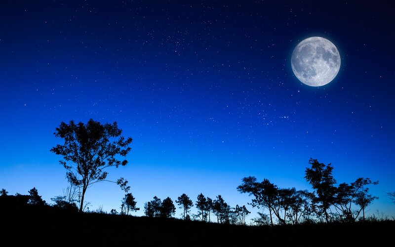 Moonlit night sky with stars