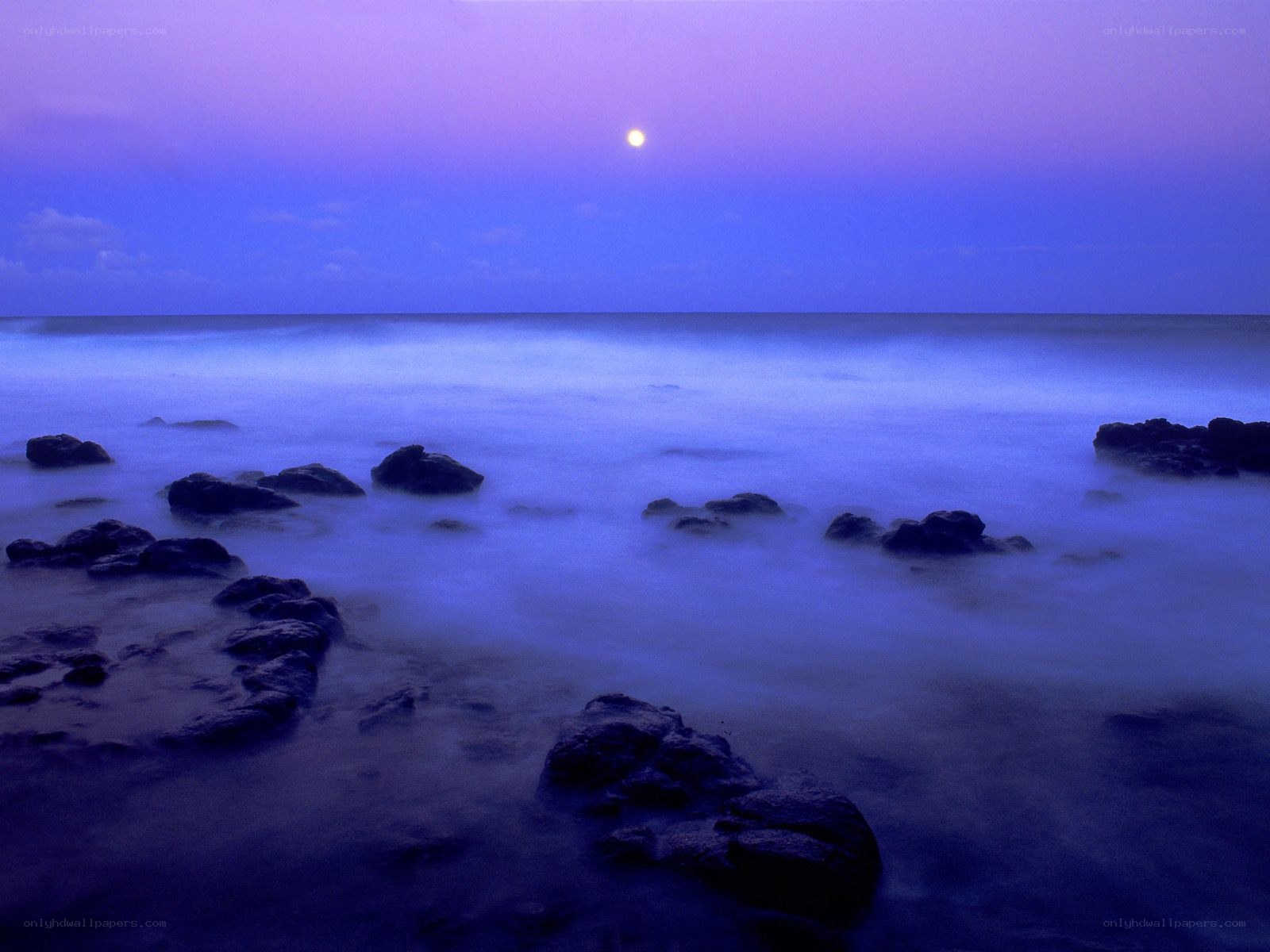 Moonlit ocean at twilight