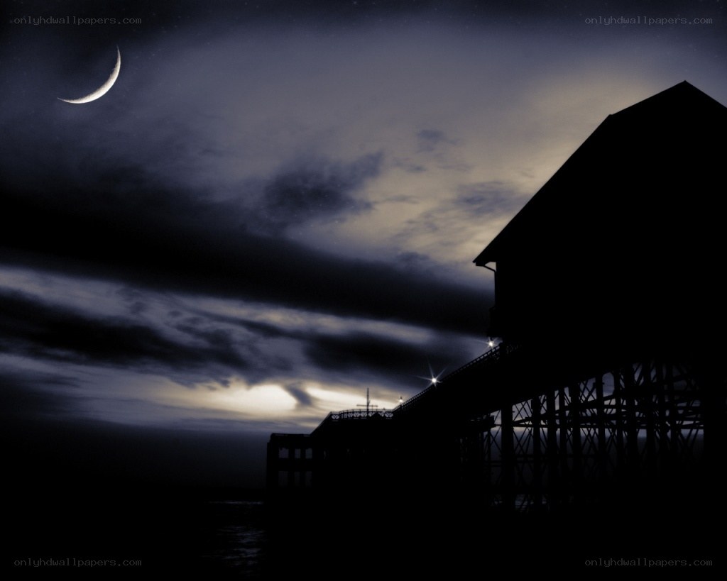 Moonlit pier at night