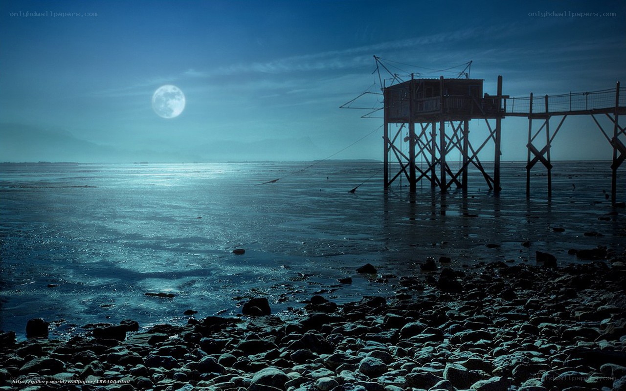 Moonlit pier at night