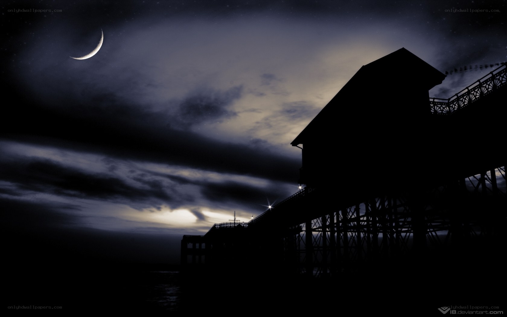 Moonlit pier at night