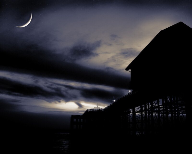Moonlit pier at night