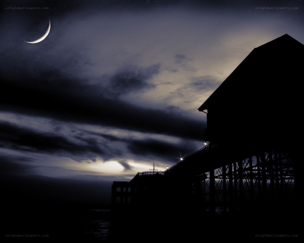 Moonlit pier at night