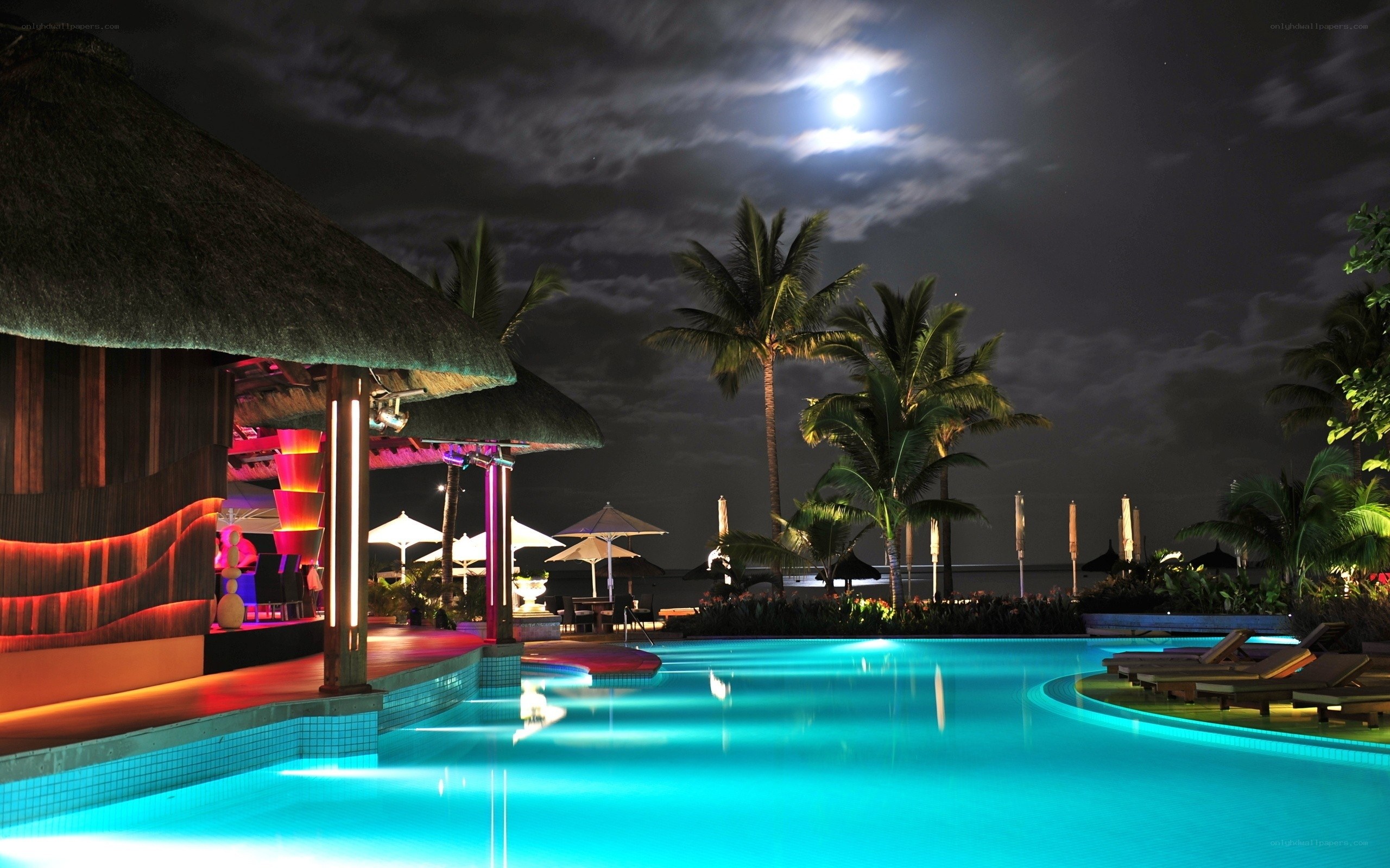 Moonlit pool at tropical resort
