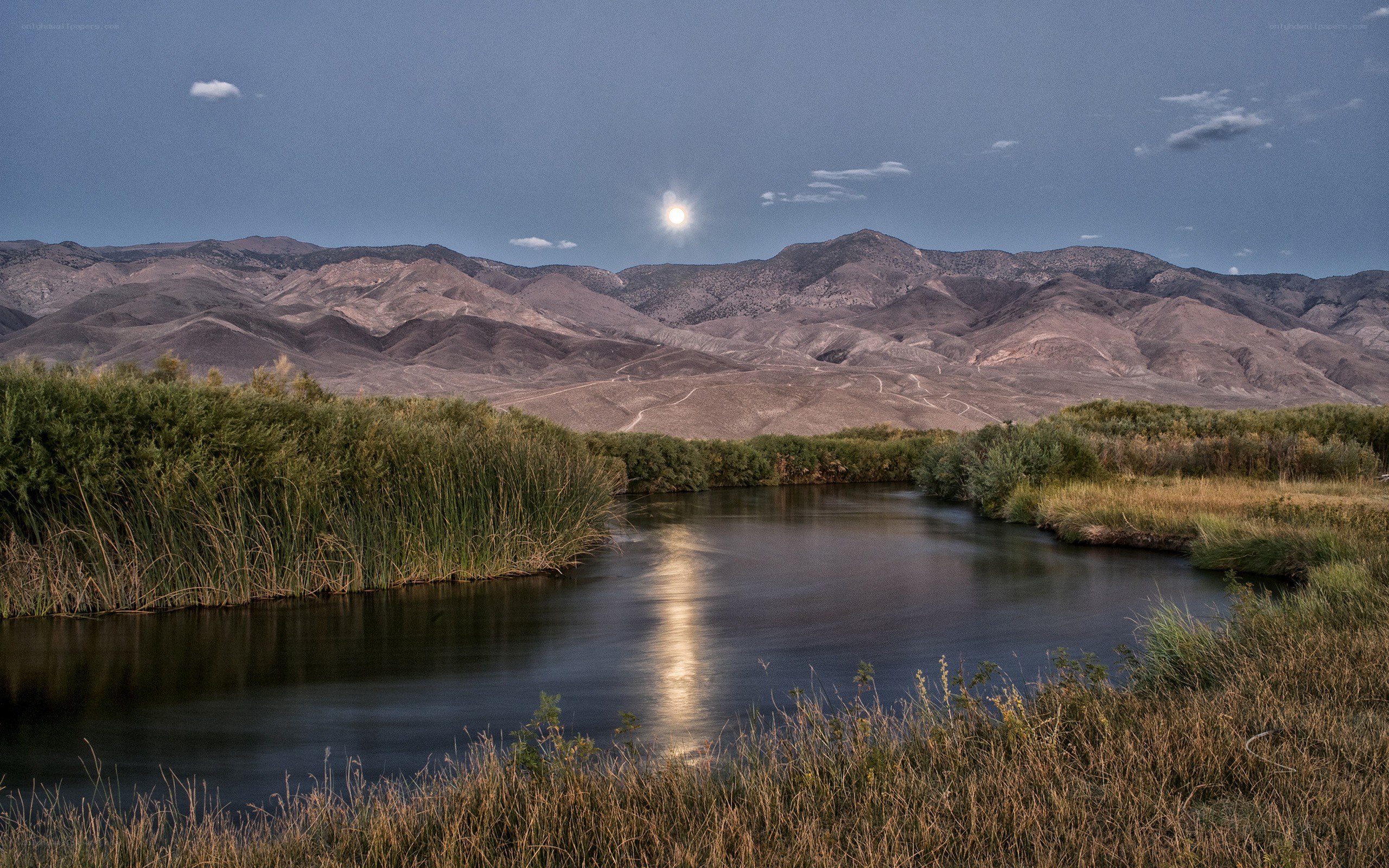 Moonlit river in desert valley
