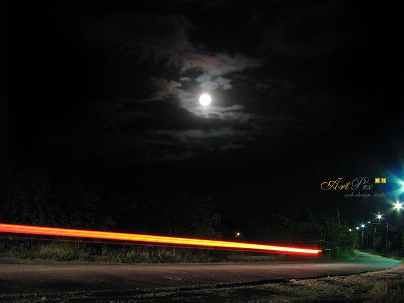 Moonlit road with light trails