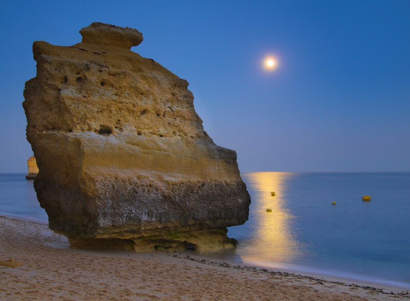 Moonlit rock formation on beach